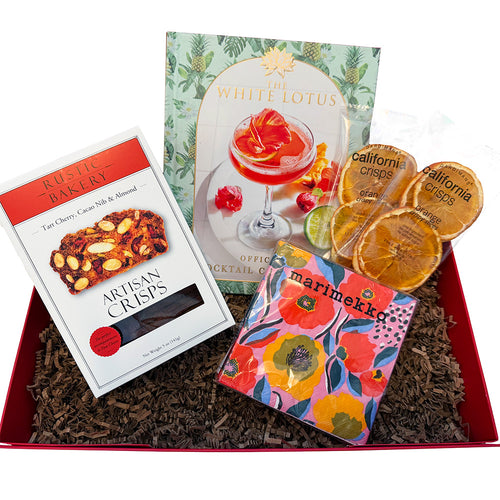 Gift box with 'Rustic Bakery' crisps, 'White Lotus' cocktail book, and 'Marimekko' packaging.