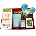 Gift box with organic sourdough bread, melatonin bath soak, tea, and a heart-shaped eye pillow on a white background