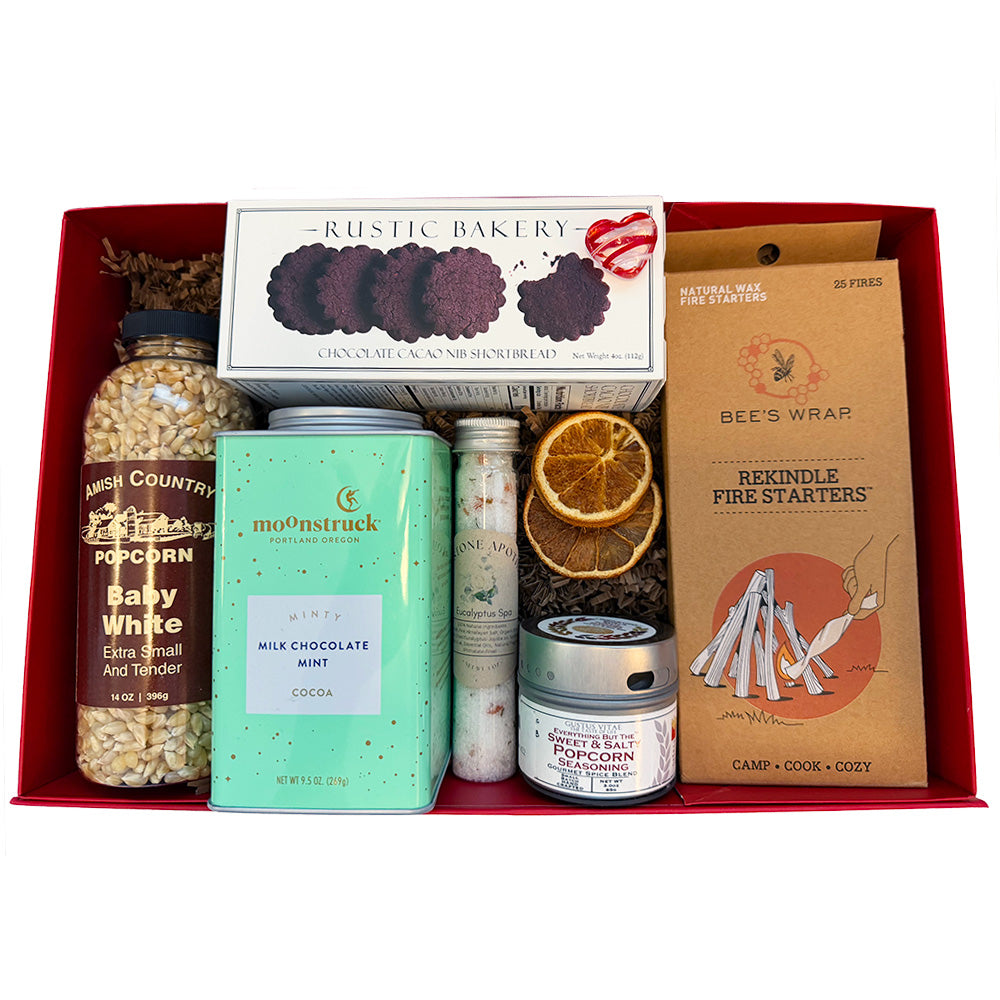 Assorted items including popcorn, chocolate, and fire starters in a red box.