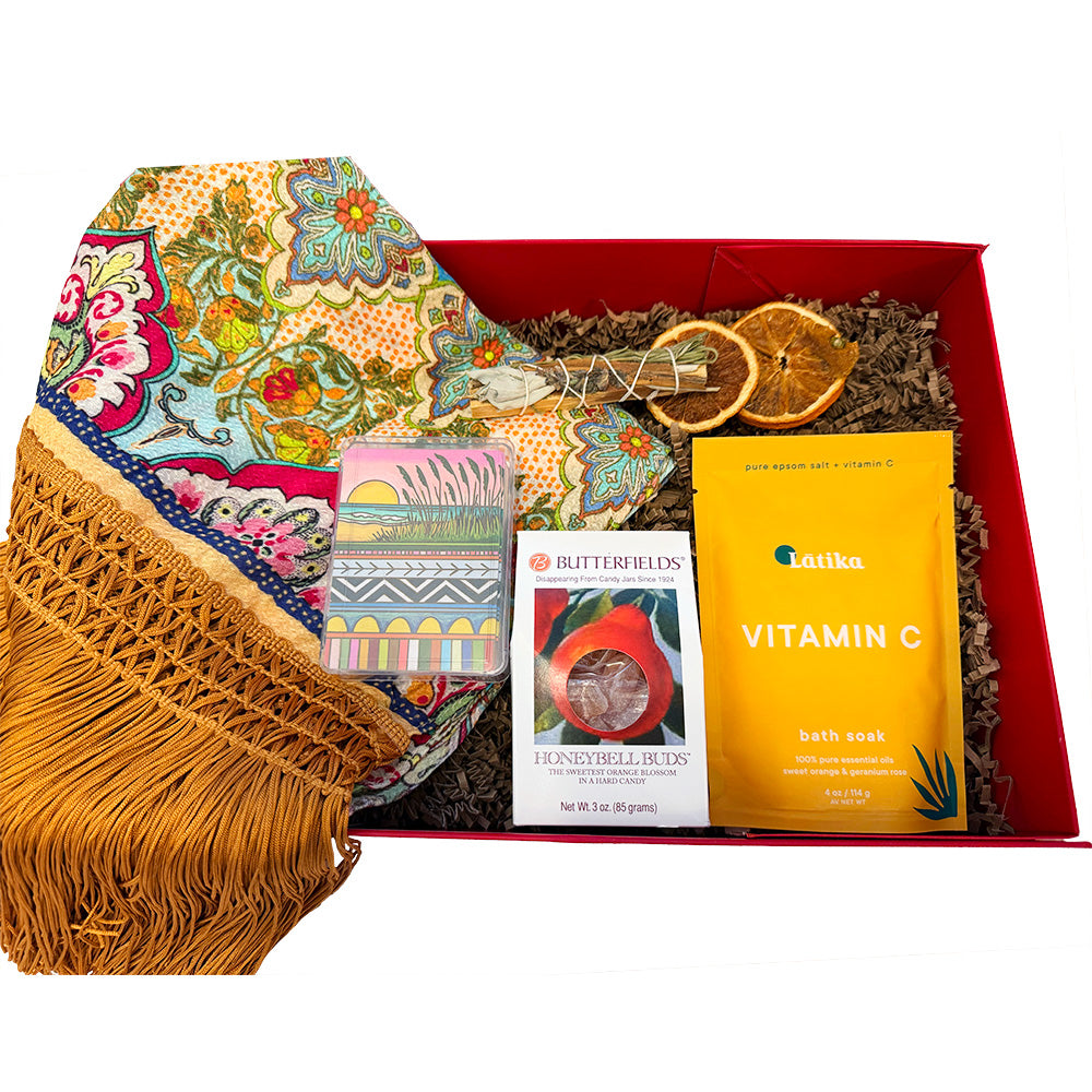 Beach themed gift box with a colorful kimono, playing cards, hard candy, and bath soak.