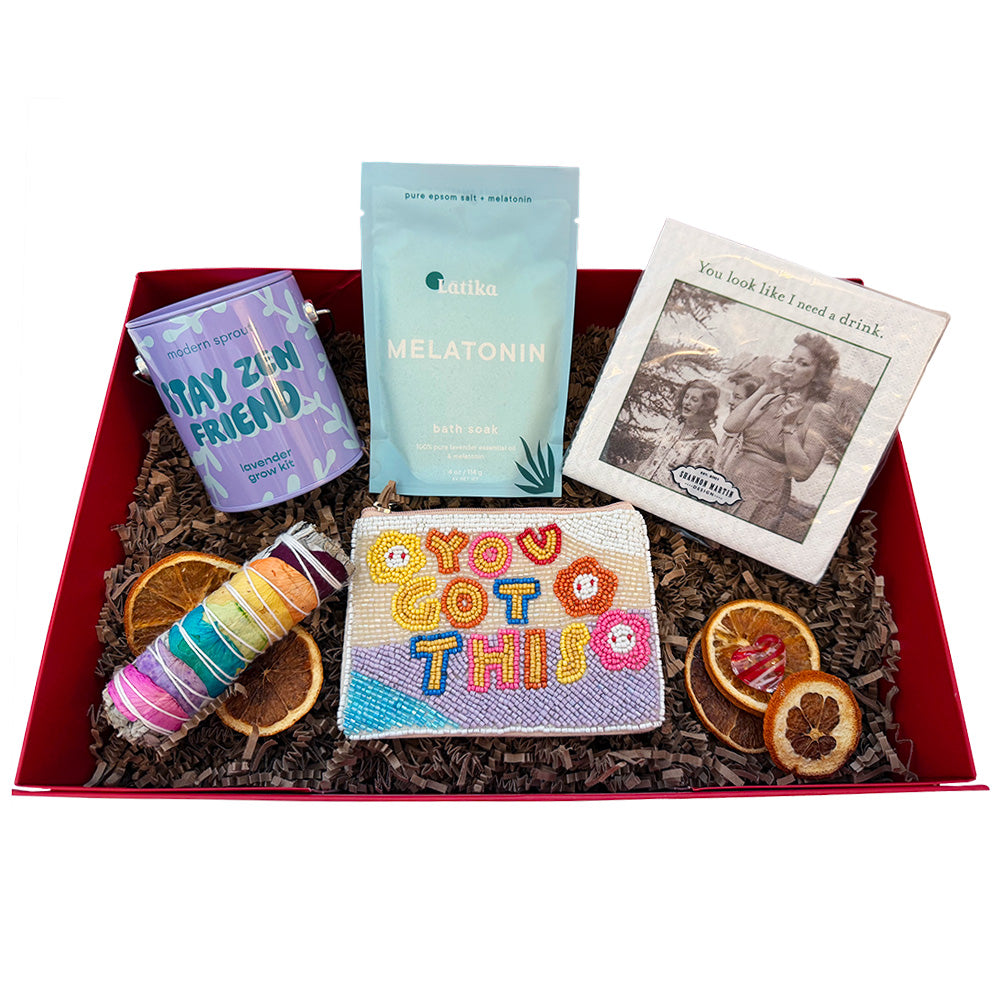 Assorted items including a beaded pouch, bath soak, and dried oranges in a decorative box.